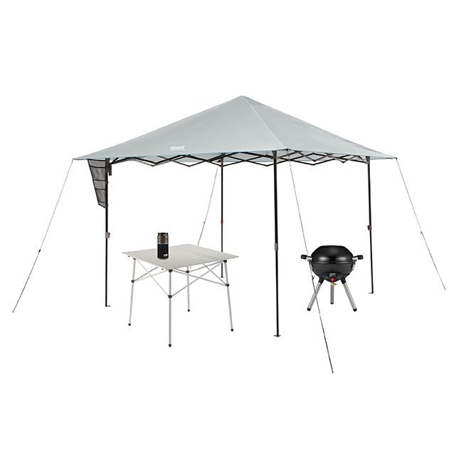 10x10 Onesource Eaved Shelter, 4in1 Portable black stove, Portable Onesource Speaker, and Compact outdoor table.