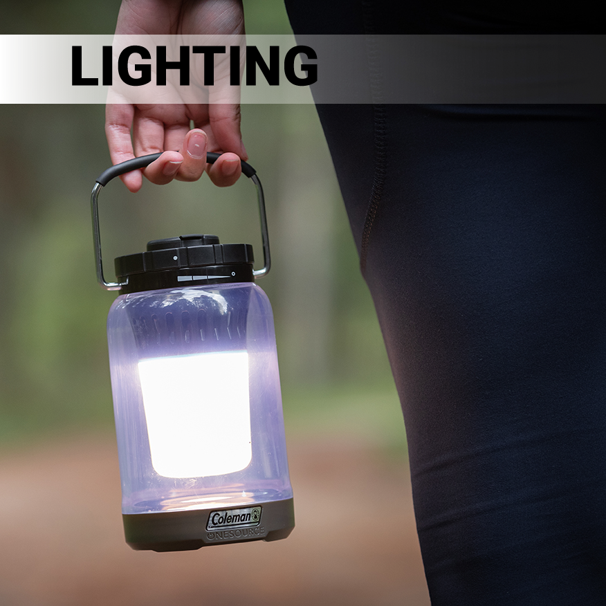 Person carrying lighted Coleman OneSource 600L Lantern in wilderness